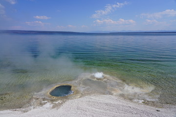Fototapeta na wymiar View of a geyser in the Yellowstone Lake in the West Thumb Geyser Basin in Yellowstone National Park, United States