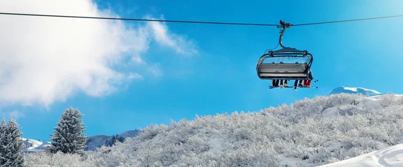 Fototapeten winter vacation - chair lift above snowy mountain landscape at ski resort © ronstik