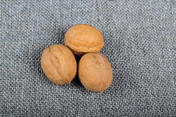 whole walnuts on burlap background, healthy food