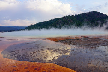Sunset fumes over the Grand Prismatic pool in Yellowstone National Park, United States