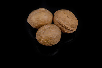 Walnuts isolated on black background with reflection