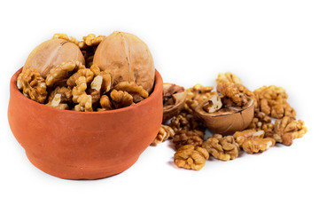 walnut kernels isolated on white background, in ceramic pot