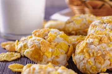 Tasty and beautiful cornflakes cookies and a glass of milk on a wooden table