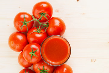 Glass of tomato juice with tomatoes
