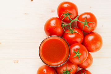 Glass of tomato juice with tomatoes