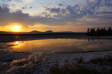 Sunset fumes over the Grand Prismatic pool in Yellowstone National Park, United States