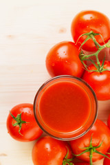 Glass of tomato juice with tomatoes