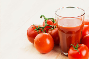 Glass of tomato juice with tomatoes