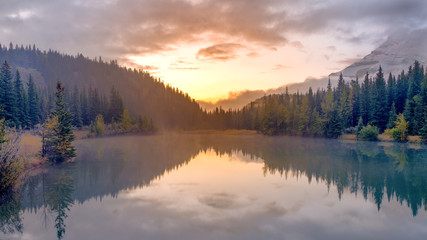 Long exposure photography of water reflection of casecade Pond during sunrise at Banff National par