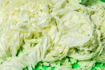 Sliced Chinese cabbage on a green board for the whole frame