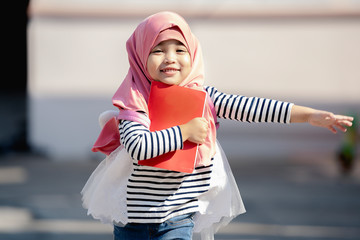 Asian Muslim child girl is happy for going to school. education concept.