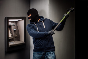 Fototapeta na wymiar Thief. Hacker stealing money from ATM machine. Phishing, ATM skimming