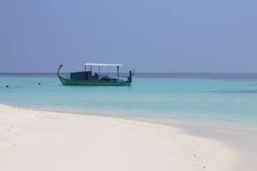 Isolated traditional maldivian boat called "Dhoni" (Ari Atoll, Maldives)