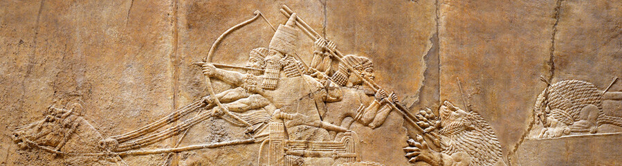 Assyrian wall relief of lion hunt, ancient history of Babylon and Shumer - obrazy, fototapety, plakaty