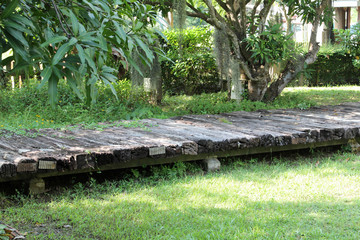 Wooden sleepers path for walking pedestrians in the garden.