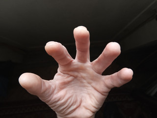 Human hand on a dark background. Fantastic figure. Body. Five fingers
