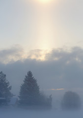 A narrow halo above a country landscape in cold winter day
