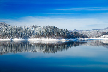 Gorski kotar, Lokvarsko lake in Croatia, beautiful mountain landscape in winter, forest reflecting in the water 