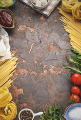 pasta and ingredients for cooking on dark background, top view, copy space © Юлия Барычева