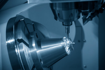 The   5-axis CNC milling machine  cutting the aluminium turbine part.The hi-precision CNC milling machine.