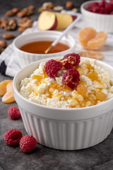 cottage cheese with fresh berries, honey, apples,  tangerines, and nuts, healthy breakfast, diet vegetarian food