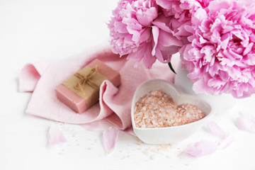 bars of handmade soap,  soft towels and peony flowers