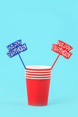 Red paper cups and happy birthday spikes