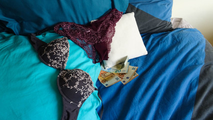 paying for sex and love concept, euro banknotes left on a pillow as payment for service of a...