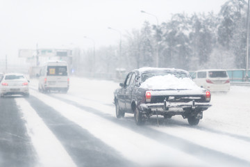 Highway with a lot o snow after a blizzard. dangerous driving. Car on a winter road