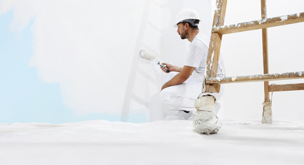 painter man at work, with wooden ladder and  blank wall for copy space, web banner template