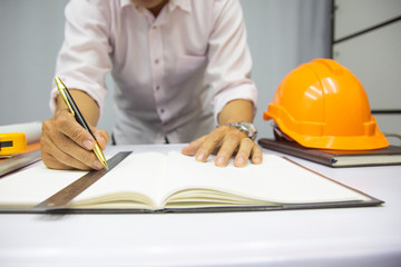 Working process startup. Engineer working at the wood table . Modern notebook on table. Pen holding...