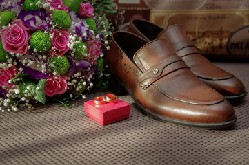 Groom shoes, bridal bouquet and wedding rings. Wedding. Morning groom.