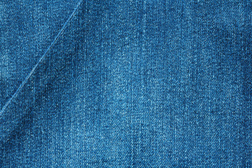 Fototapeta na wymiar denim fabric with diagonal fold as background