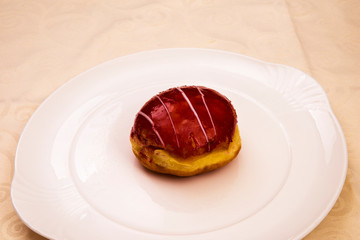 Single vanilla raspberry jelly-filled donut on a china plate, Baden Wuerttemberg, Germany, Europe