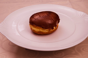 Single chocolate-filled donut on a china plate, Baden Wuerttemberg, Germany, Europe