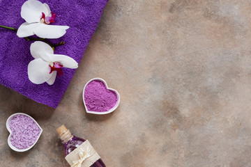 Orchid flower, aroma sea salt, sea mineral essence, natural cosmetic clay, and towel. Natural skin care. Spa kit for beauty and health. Close up, top view