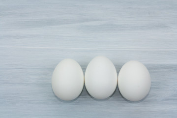 Eggs on wooden background. Healthy food and easter symbol.
