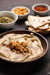 Classic Hummus with chickpeas, paprika, olive oil and oriental spices. Mediterranean popular snack of chickpeas and tahini pasta.