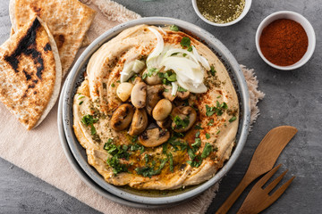 Traditional Mediterranean hummus with mushrooms and onions. Classic Hummus with paprika, olive oil, onions, mushrooms and seasonings