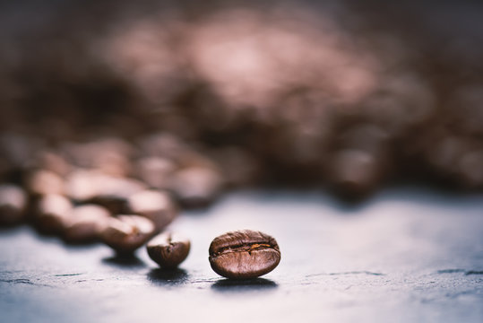 Coffee beans on a black background. Raw coffee beans. Grained product. Hot drink. Close up. Harvesting. Natural background. Energy 