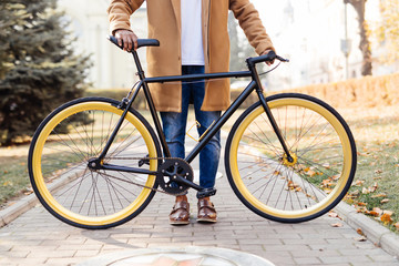 Fototapeta premium Ready to ride. Close-up of young man sitting on his bicycle outdoors