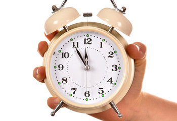 Alarm clock in hand on white background