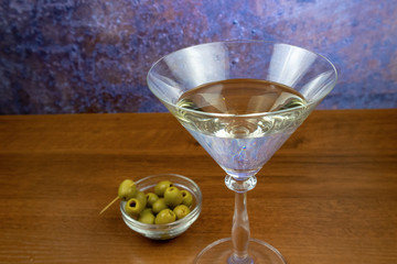 White vermouth in a martini glass with olives