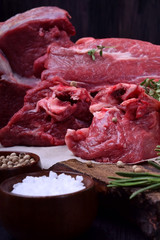 Uncooked beef meat and ribs on a wooden board. Close-up