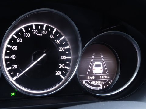 Speedometer and display of active collision avoidance system on car dashboard