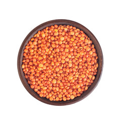 red lentils in a clay brown plate, top view, isolated on white background