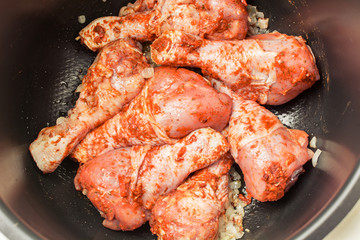 Marinated chicken legs in multicooker for frying.