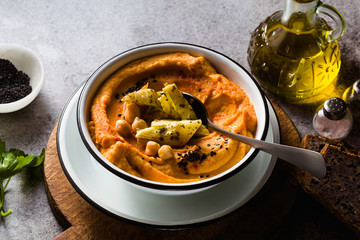 Delicious vegan hummus with sweet potato and canned artichokes. with black sesame. tasty snack of the Middle East