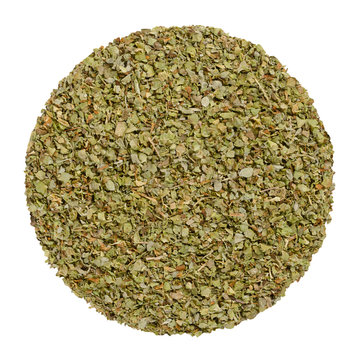 Dried marjoram, herb circle from above, isolated, over white. Disc made of Origanum majorana, also sweet, knotted or pot marjoram. Green herb and spice. Closeup. Macro food photo.