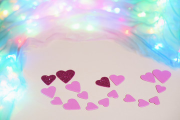 Symbolic image of Valentine's day candles, hearts, pink.